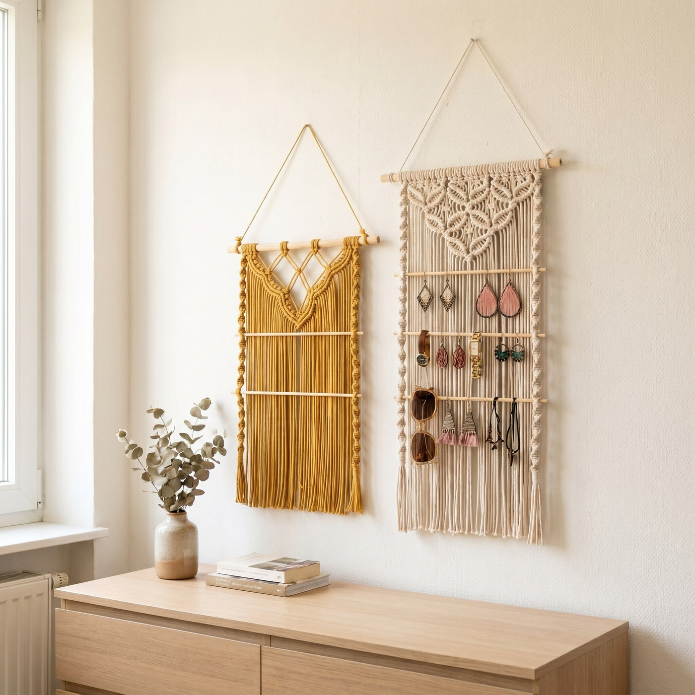 Two Ketelier macramé wall hanging organizers made of cotton cord, displaying earrings and accessories on a wooden wall.